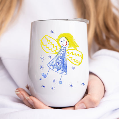 Person holding a white tumbler with a colorful drawing of an angel on it. | Little Heirloom
