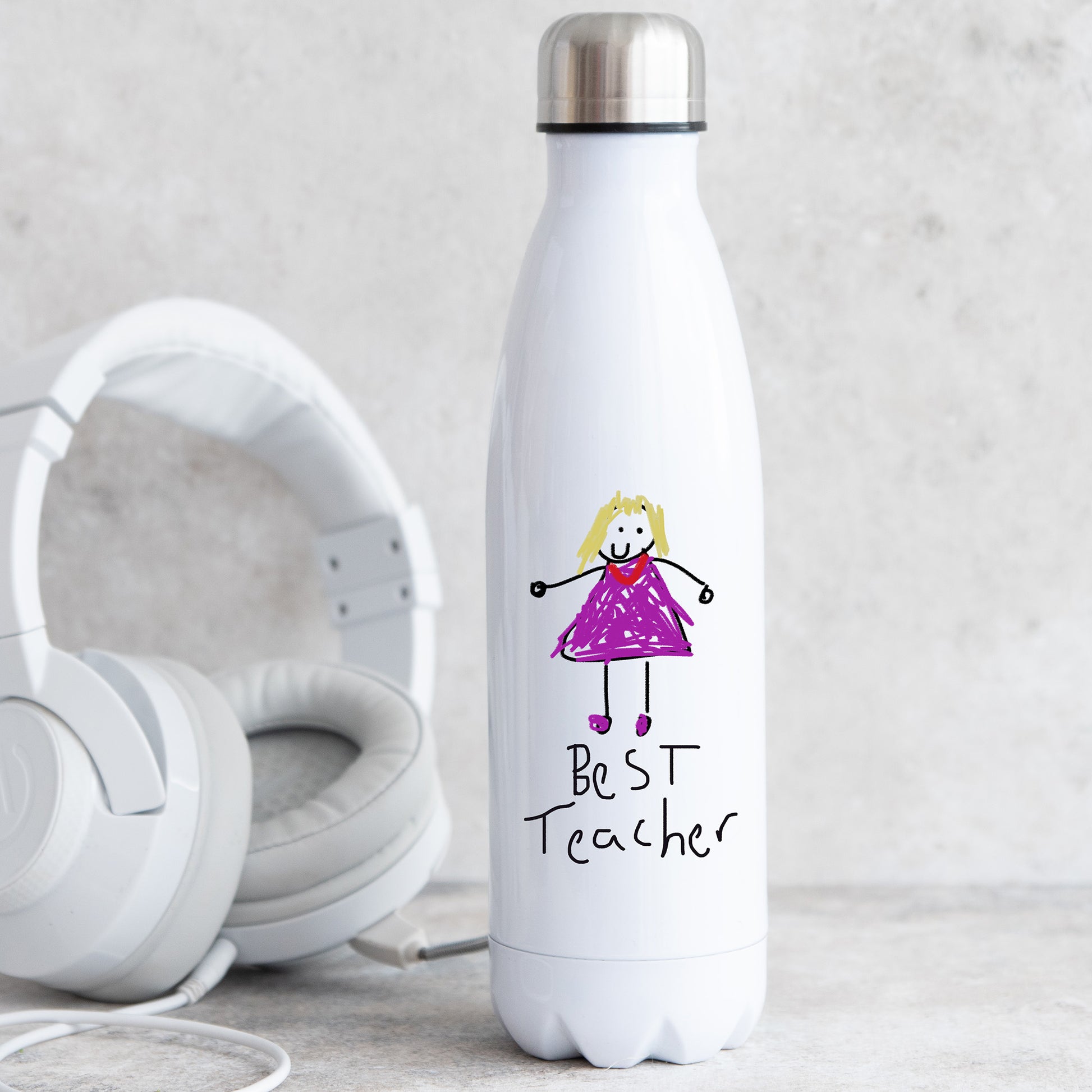 White water bottle with a drawing of a girl in a purple dress and 'Best Teacher' text, next to white headphones on a light gray background. | Little Heirloom