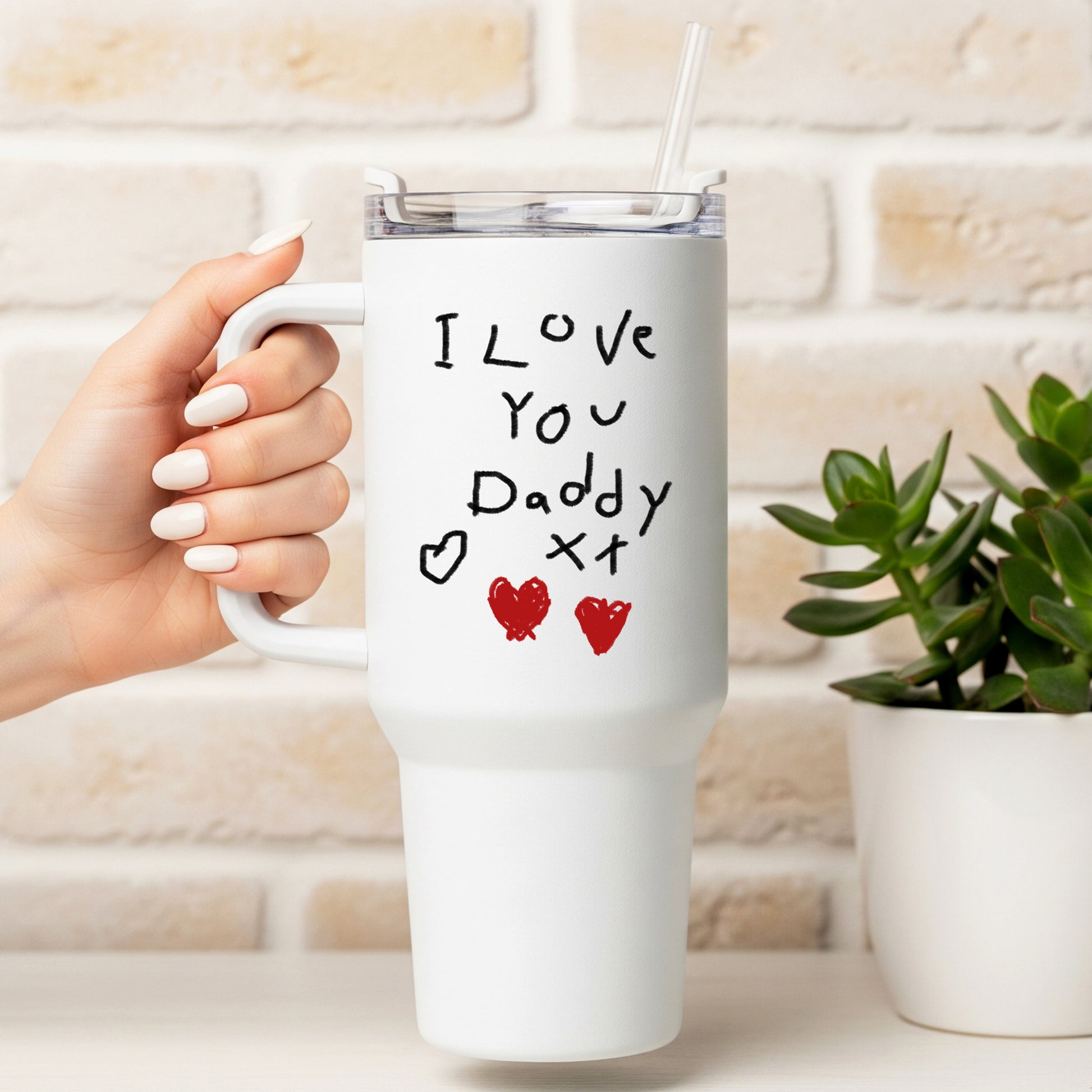 White mug with 'I Love You Daddy' text held by a hand, against a light brick wall. | Little Heirloom