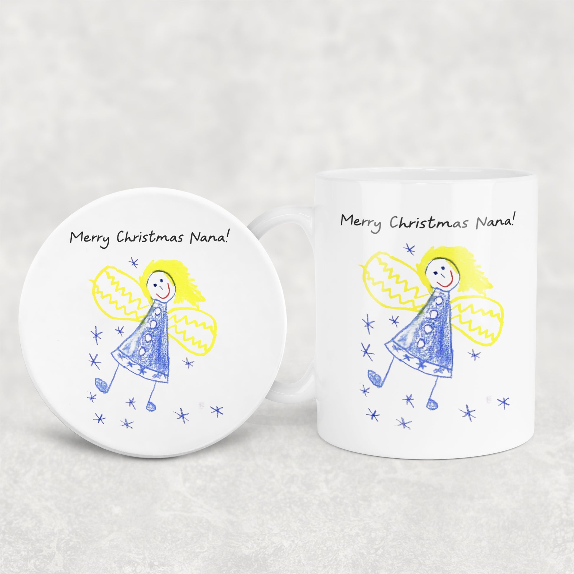 White mug and coaster set with angel illustration and 'Merry Christmas Nana!' text on a light gray background | Little Heirloom