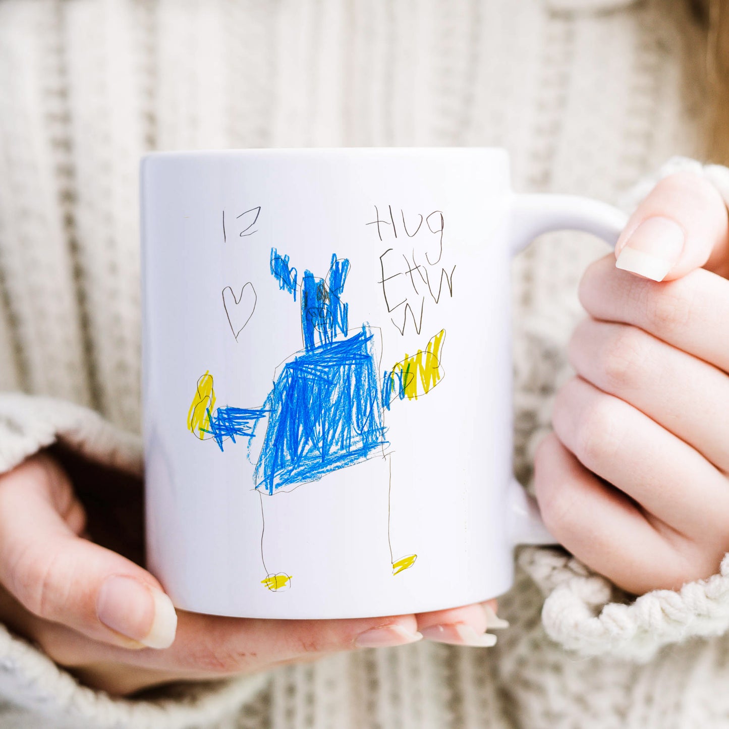 Person holding a mug with a child's drawing and text 'I love you' on a soft background | Little Heirloom