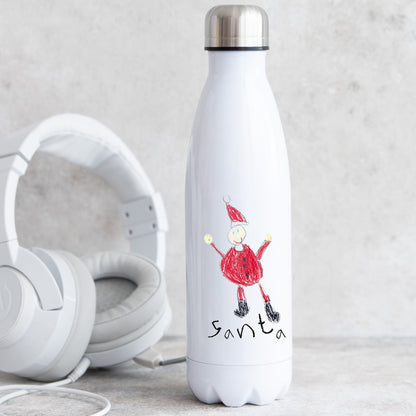White insulated bottle with a drawing of Santa Claus next to white headphones on a light gray surface. | Little Heirloom