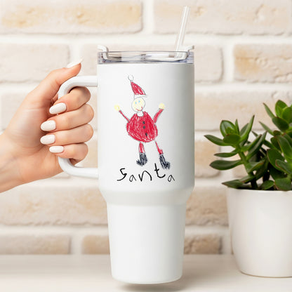 White travel mug with a drawing of Santa Claus held by a hand, against a light brick wall background. | Little Heirloom